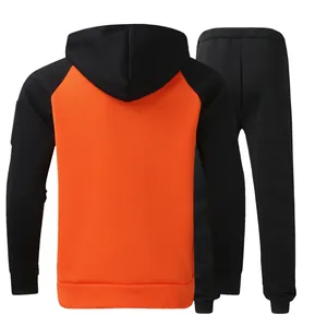 Back view of a men's orange and black color-block hoodie and jogger tracksuit set