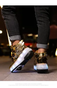 Detailed macro shot of metallic gold LED roller shoes with wings for kids on street