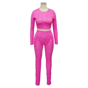 High-waisted pink ribbed leggings and long-sleeve crop top set displayed on mannequin