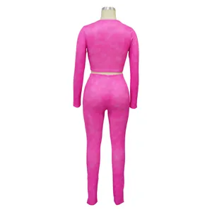 Back view of pink ribbed two-piece set with long sleeve crop top and leggings