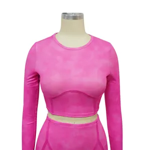 Detailed view of pink ribbed long-sleeved crop top featuring under-bust seam design