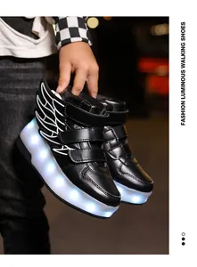 Detailed view of black children's LED walking shoes with glowing soles and wing decorations