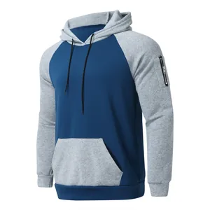 Detail view of two-tone fleece hoodie featuring raglan sleeves and sleeve zipper pocket