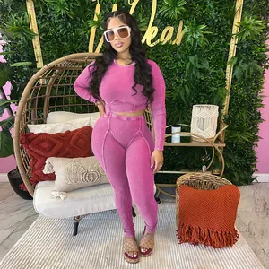 Full body view of women's pink ribbed long sleeve crop top and matching high waist leggings