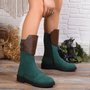 Close-up of green and brown mid-calf knight boots with side zipper and chunky sole