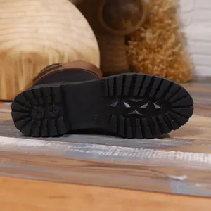 Detailed view of durable anti-slip rubber sole for women's mid-calf leather knight boots.