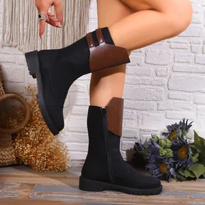 Stylish black mid-calf knight boots with brown cuff, side zipper and low heel details.