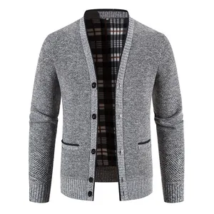 Close-up of men's thick knit cardigan featuring textured grey fabric and plaid lining detail