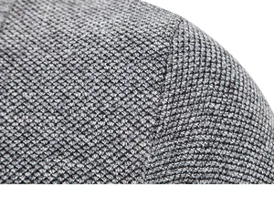 Macro view of grey and white thick textured knit fabric on a men's cardigan.