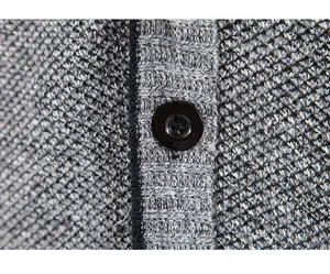 Close-up detail of thick knit cardigan texture and black button for men's winter style