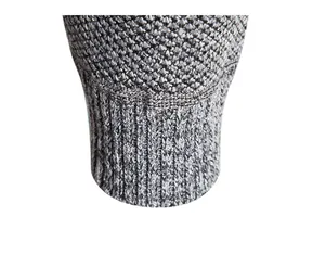 Close-up macro view of high-quality grey marled knit texture and ribbed sleeve cuff