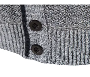 Macro detail of men's knitted cardigan sweater showing buttons and ribbed texture
