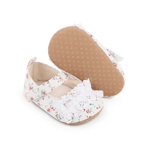 Detailed view of floral baby walking shoes with white lace trim and non-slip soles.