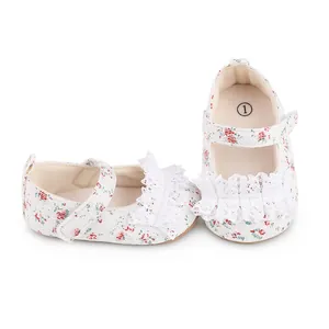 Detail of floral print baby walking shoes featuring delicate white lace trim and ruffles