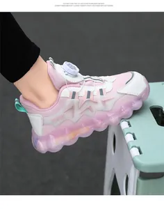 Close-up detail of pink children's sneaker featuring a rotating buckle and thick wavy sole.