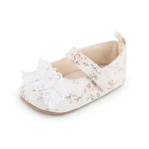 Close-up of floral lace baby walking shoe with delicate white ruffle decoration