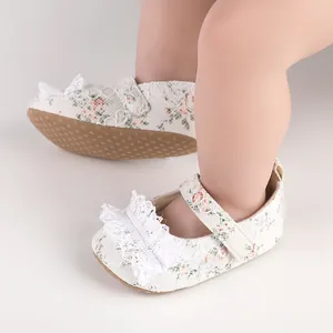 Close-up detail of white lace floral baby girl walking shoes with a soft non-slip sole