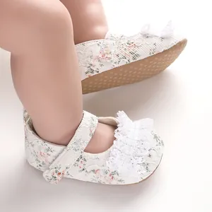 Close-up detail of floral lace baby walking shoes featuring a soft non-slip sole