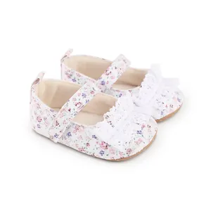 Detailed view of baby girl floral walking shoes with white lace ruffles and strap.