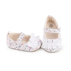 Detailed view of baby walking shoes featuring floral fabric and delicate white lace ruffles