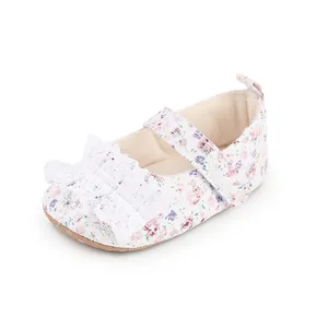 Detailed close-up view of a floral lace baby Mary Jane walking shoe with a secure velcro strap