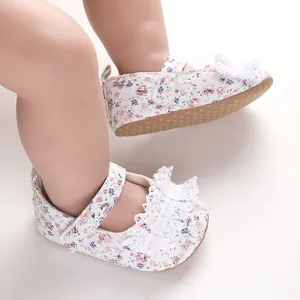 Detailed macro shot of floral lace baby walking shoes with white ruffles and soft soles