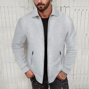 Detailed view of men's light gray waffle knit zip-up jacket with collar and zipper pockets