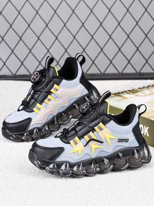 Detail of waterproof children's sports shoes with rotary buckle and bubble sole.