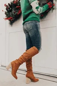 Chunky heel brown suede over-the-knee boots with side zipper in festive setting