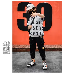 Children wearing waterproof leather sneakers with rotary buckle closure in street setting