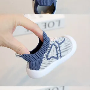 Detailed close-up of blue fly-knit baby sock shoe showing elastic collar and soft sole