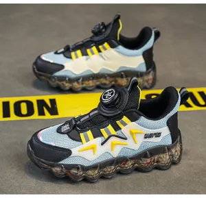 Detailed view of kids' sports shoes featuring a rotary buckle and translucent bubble sole