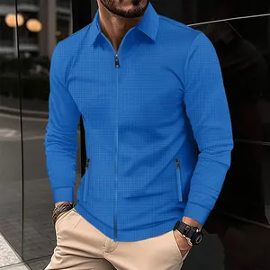 Detail view showing texture of a blue waffle knit zip-up jacket for men