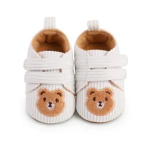 Close-up showing the soft corduroy texture and bear embroidery on baby walking shoes