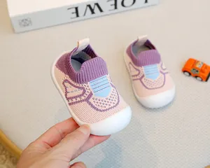 Detail of pink and purple breathable flying woven baby shoes with soft white sole.