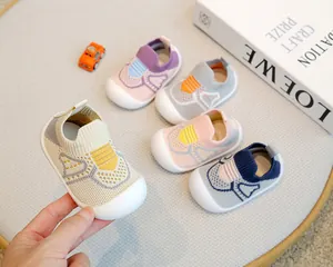 Detailed view of non-slip soft-soled baby knit sock shoes in various pastel colors