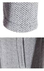 Detalle macro de tejido de punto bouclé gris que muestra textura y costuras acanaladas