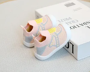 Detailed view of breathable pink fly-knit upper and soft non-slip rubber sole on baby shoes.