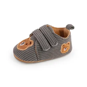 Detail view of gray corduroy baby walking shoes with cute embroidered teddy bears