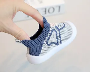 Detailed view showing the breathable and flexible fly-woven fabric of baby soft sole shoes