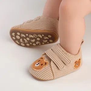 Close-up of baby walking shoes with bear embroidery and anti-slip corduroy soles