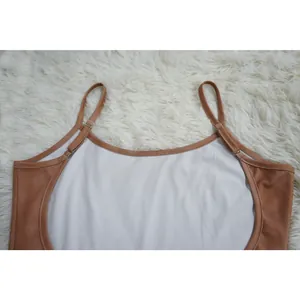 Detailed macro view of ribbed U-neck camisole bodysuit featuring contrast trim detail