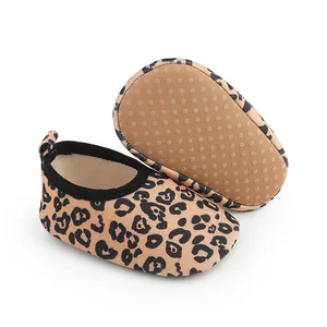 Close-up of leopard print baby walker shoes featuring anti-slip dotted rubber soles.
