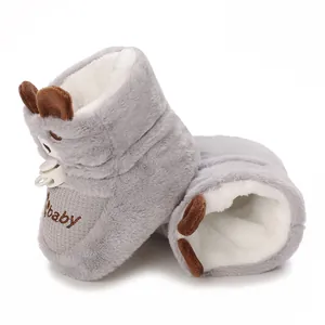 Detailed view of gray plush baby winter boots with fleece lining and toggle closure.