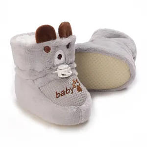 Close-up of cute grey plush baby boots with warm lining and non-slip sole design