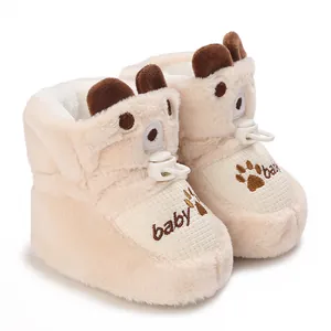 Detail view of cream fleece-lined baby cotton boots with cute bear ear design