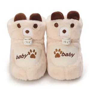 Front detail view of plush baby winter booties with cute bear ears and embroidered logo