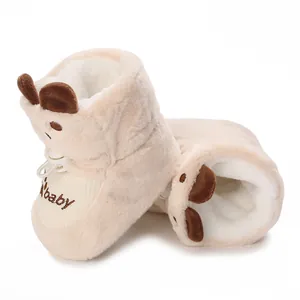 Close-up of cream fleece-lined baby boots with cute bear ears and adjustable toggle.
