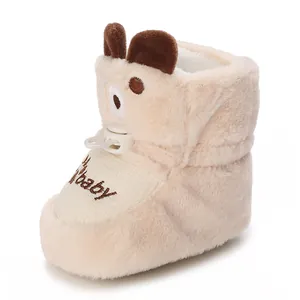 Close-up detail of cute bear-themed plush baby booties with warm and soft lining.