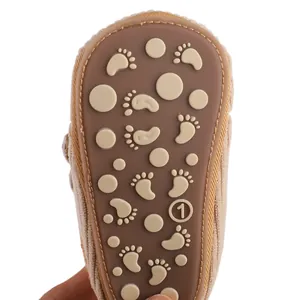 Close-up view showing the durable rubber sole and anti-slip footprint pattern of a baby shoe